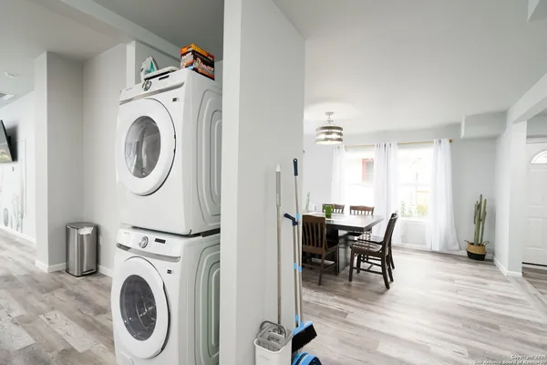 a view of a a dining room with furniture window and wooden floor