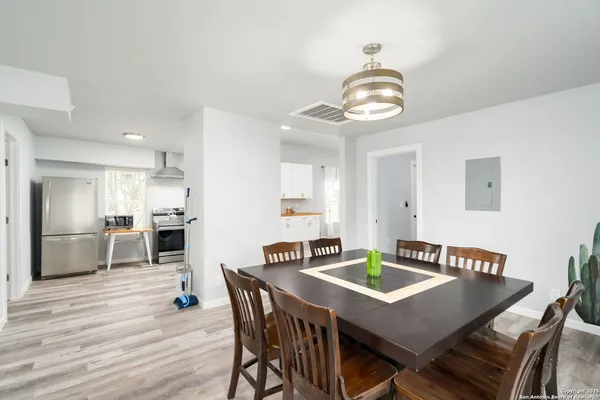 a view of a dining room with furniture and wooden floor