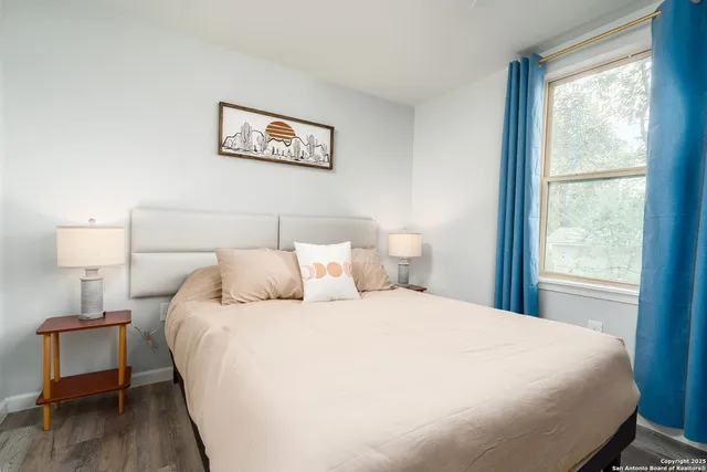 a bedroom with a bed and a lamp on table