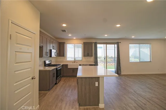 a kitchen with sink cabinets and stainless steel appliances