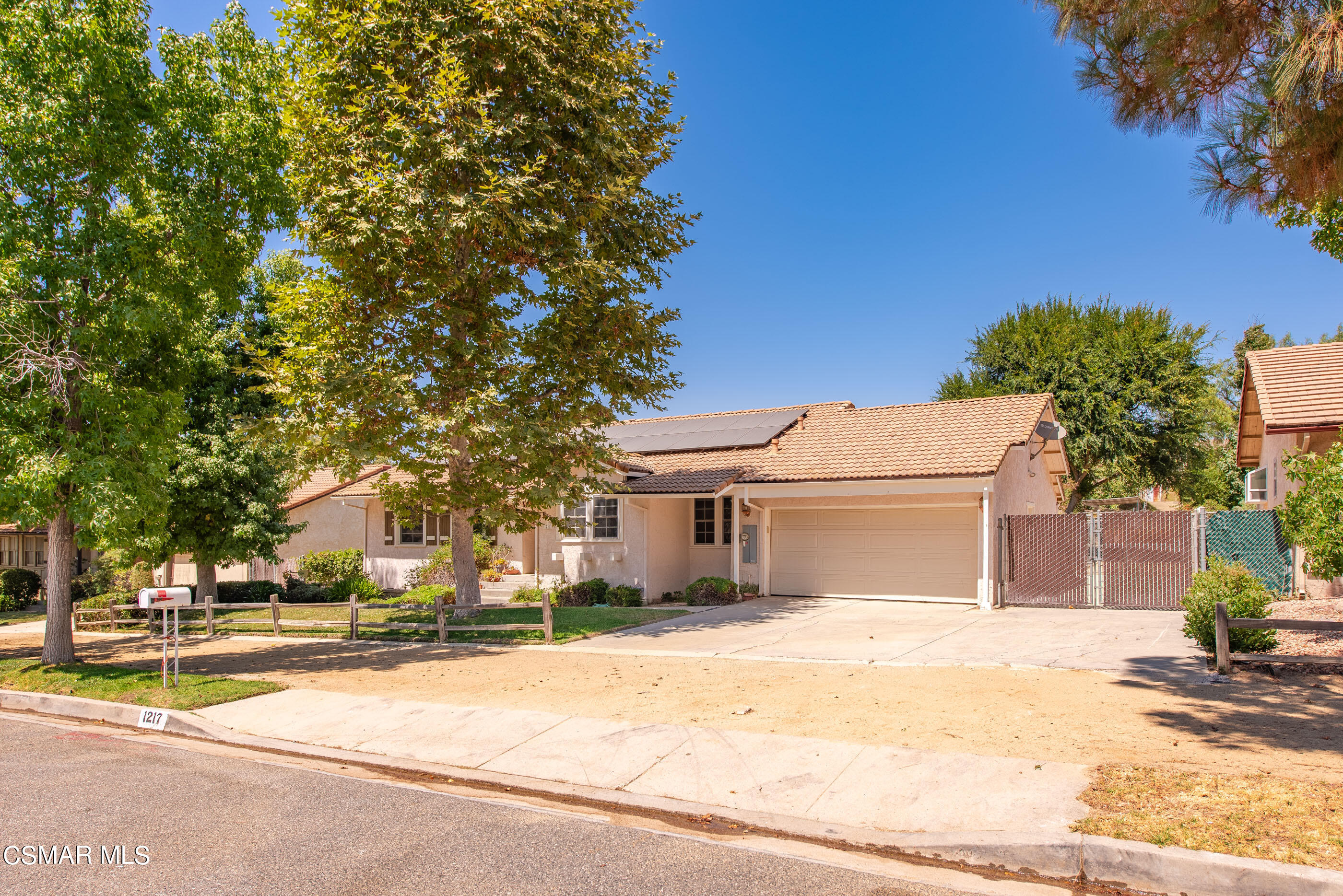 1217 Rambling Road Simi Valley, CA 93065 - Photo 3 of 64 a front view of a house with a yard and garage