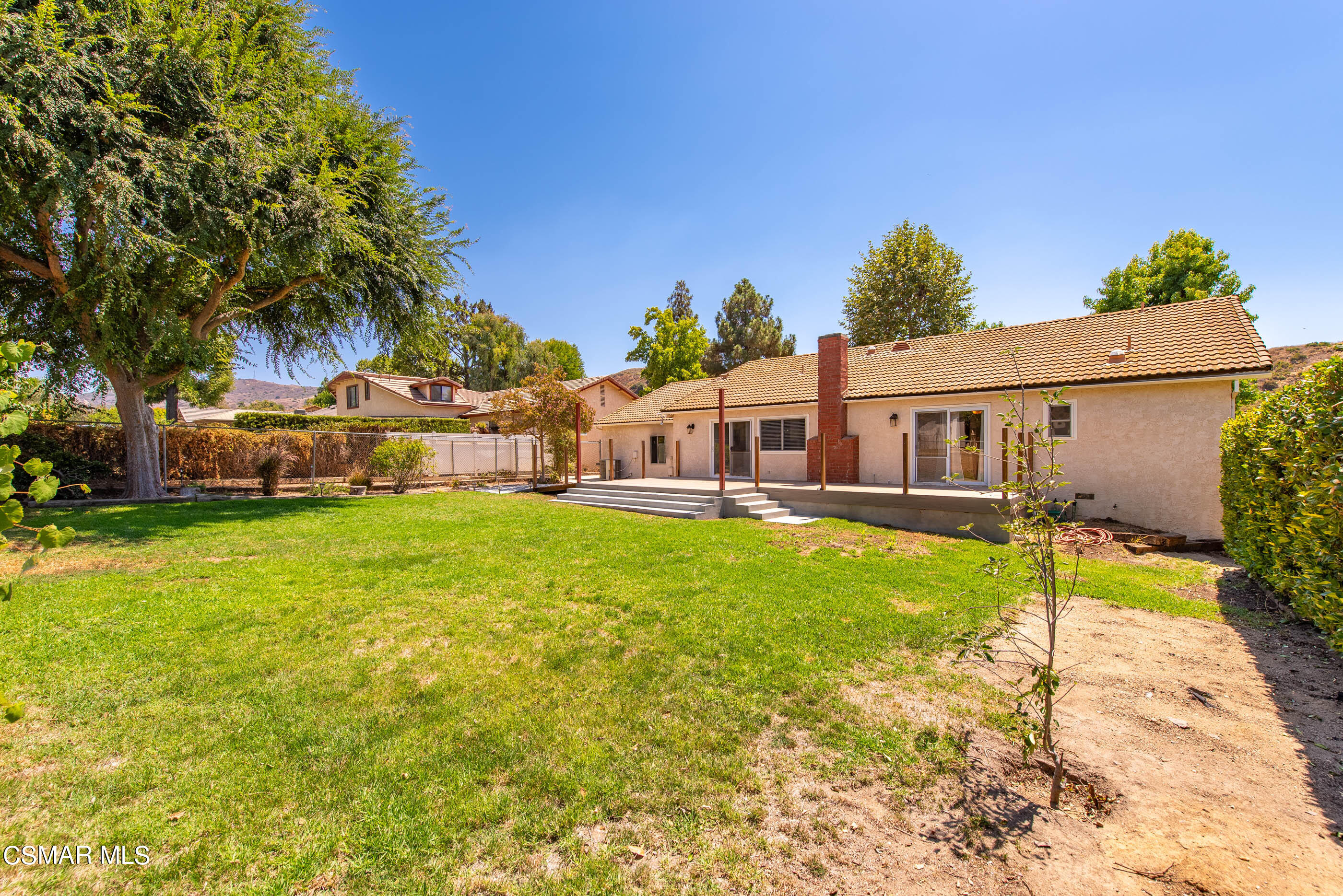 1217 Rambling Road Simi Valley, CA 93065 - Photo 31 of 64 a view of a house with a big yard potted plants and large tree