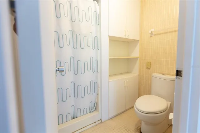 a bathroom with a toilet and a shower