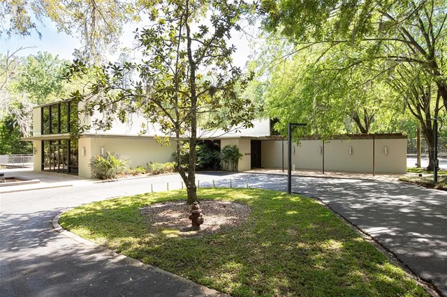 a backyard of a house with table and chairs