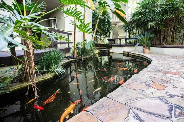 a view of backyard with swimming pool and outdoor seating