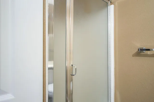 a bathroom with a glass shower door