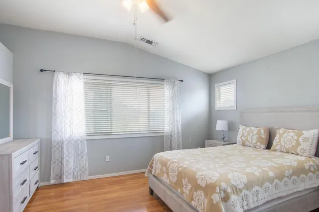 a bedroom with a bed and a window