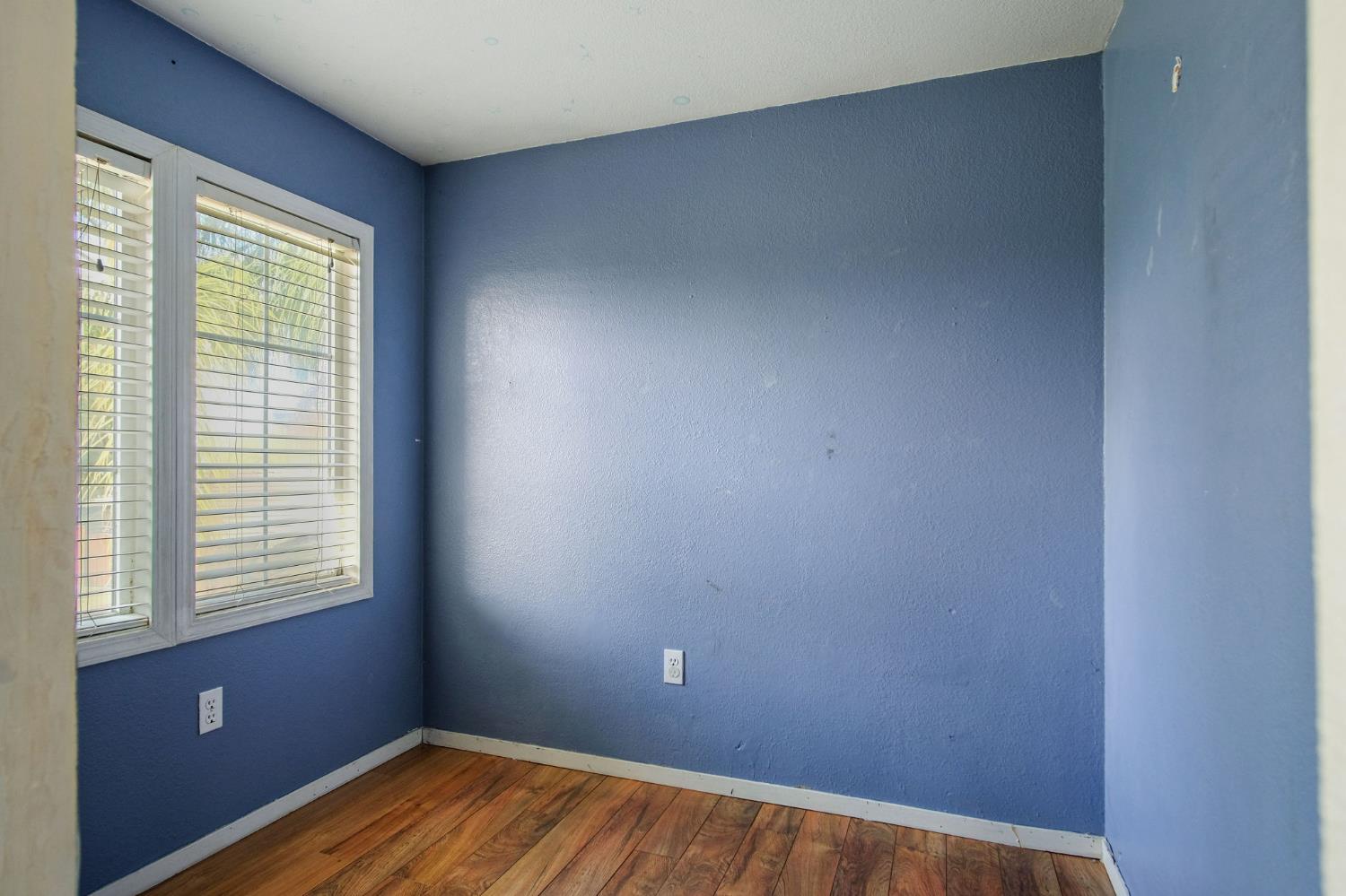 810 River Raft Court Modesto, CA 95351 - Photo 22 of 32 a view of a room with wooden floor and a window
