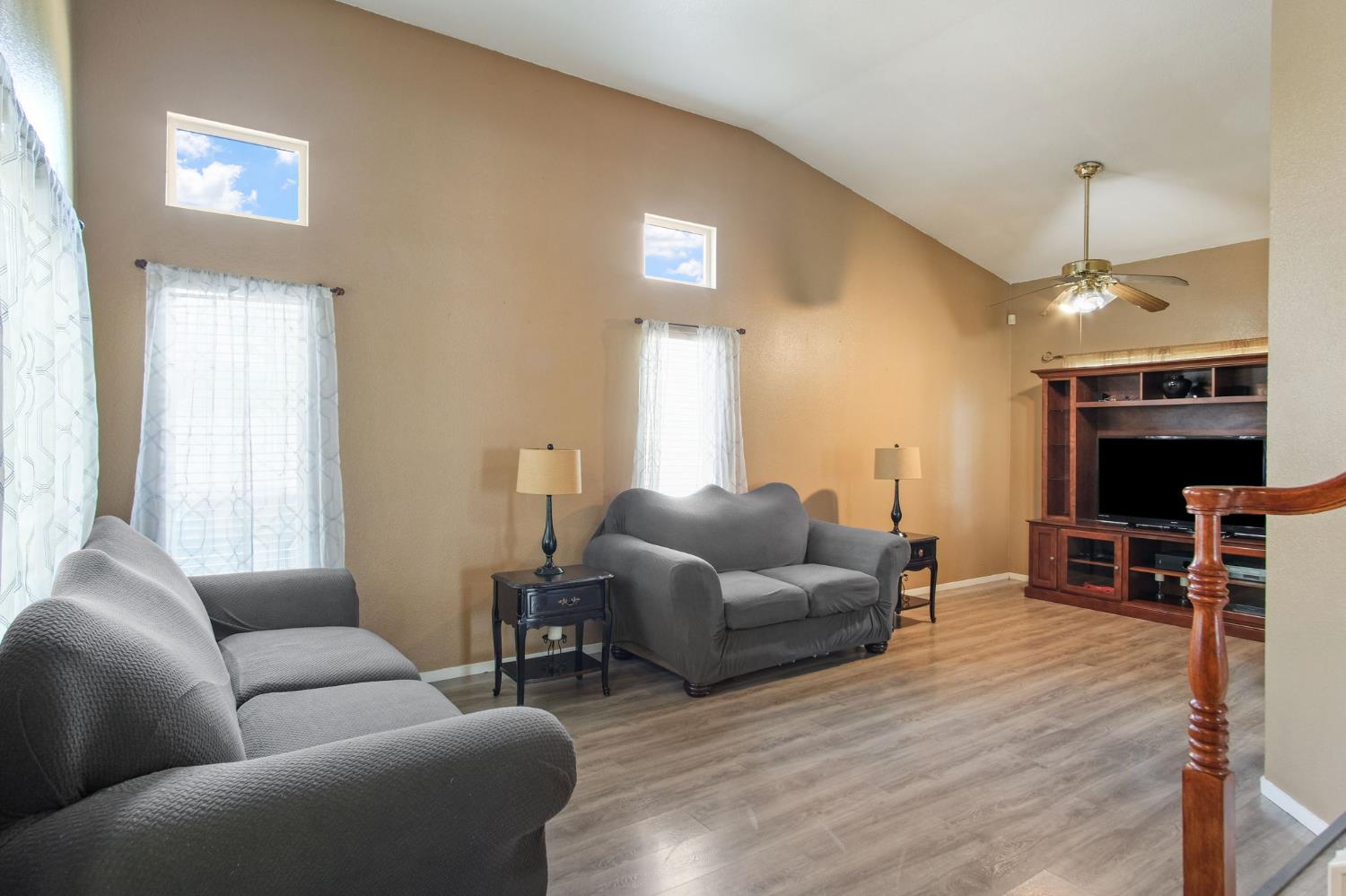 810 River Raft Court Modesto, CA 95351 - Photo 5 of 32 a living room with furniture a dining table and a fireplace