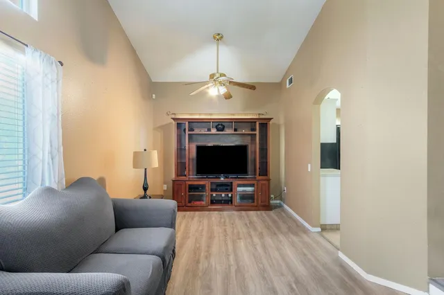 a living room with furniture and a chandelier