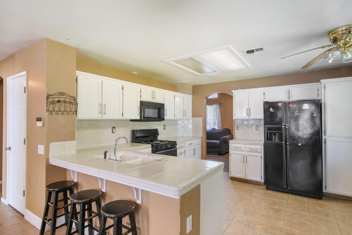 810 River Raft Court Modesto, CA 95351 - Photo 7 of 32 a kitchen with stainless steel appliances a refrigerator sink and stove