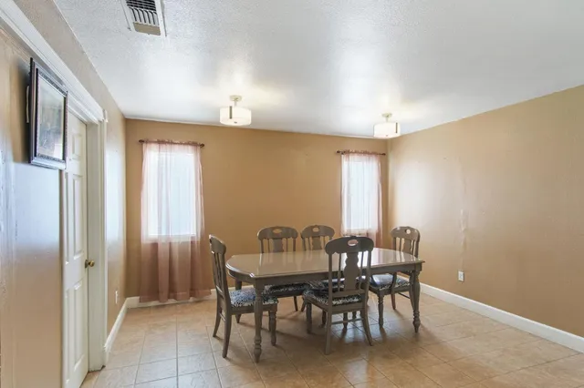 a view of a dining room with furniture and chandelier