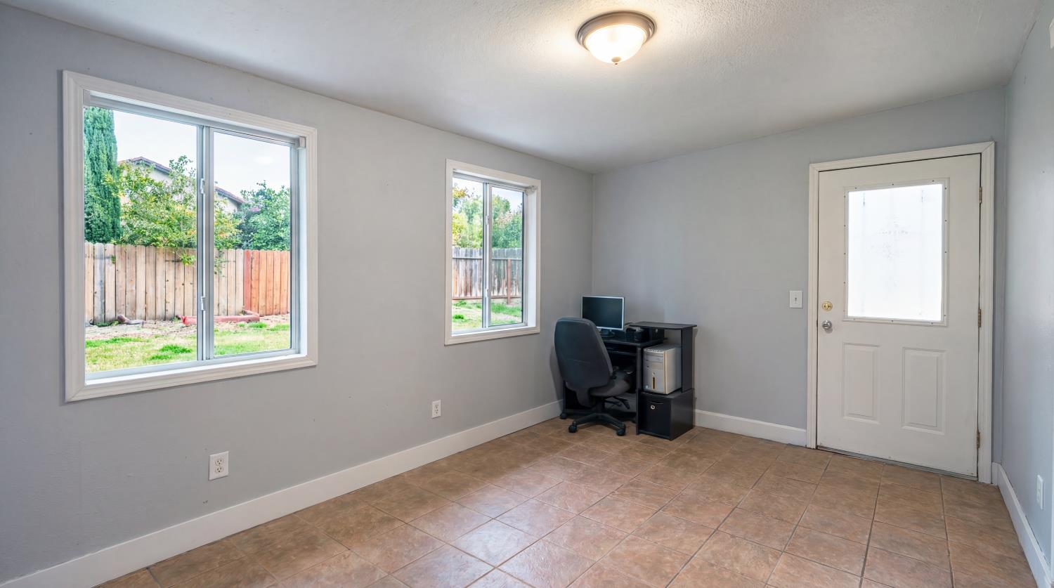 810 River Raft Court Modesto, CA 95351 - Photo 10 of 32 a view of a workspace with furniture and a window