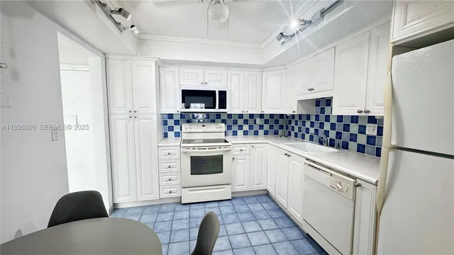 a kitchen with a stove a sink and a refrigerator