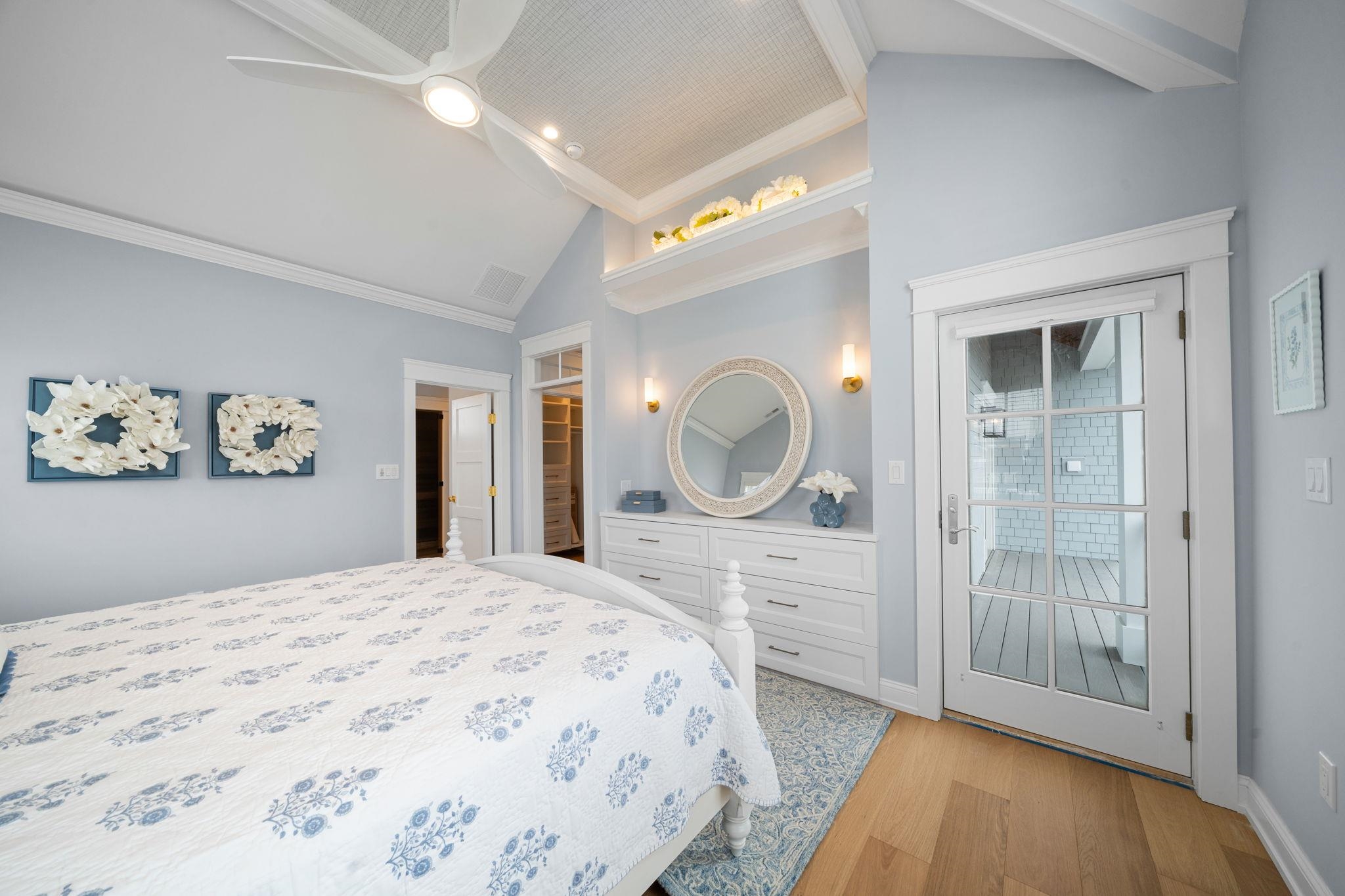 9102 3rd Stone Harbor, NJ 08247 - Photo 8 of 24 a bedroom with a bed and a chandelier