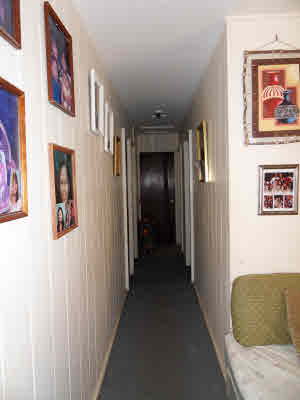 4786 Nonou Road Kapaa, HI 96746 - Photo 4 of 18 a view of a hallway with paintings on the wall