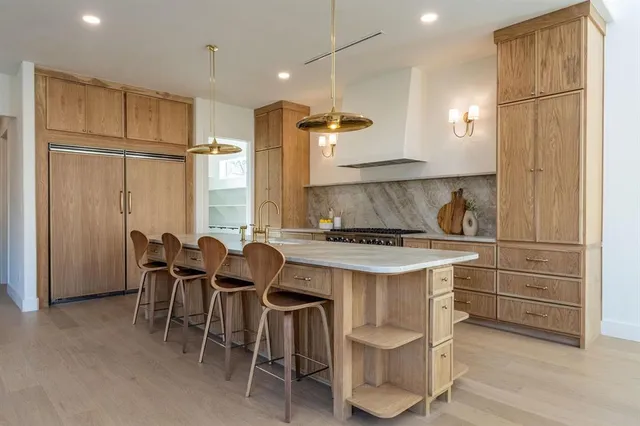 a kitchen with a table chairs refrigerator and cabinets
