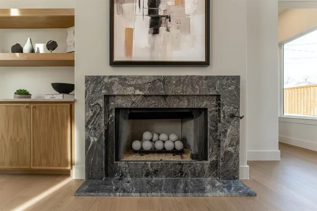 a living room with a fireplace and wooden floor