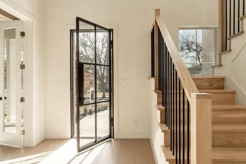 a view of a staircase with wooden floor and windows