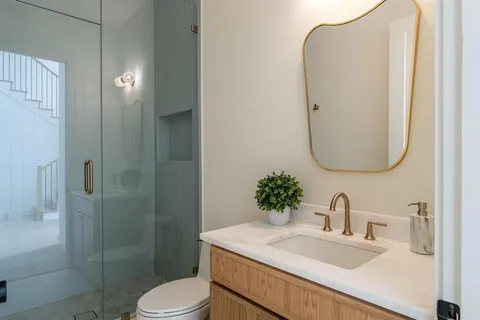 a bathroom with a sink toilet and shower