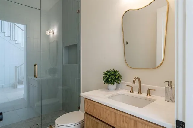 a bathroom with a sink toilet and shower