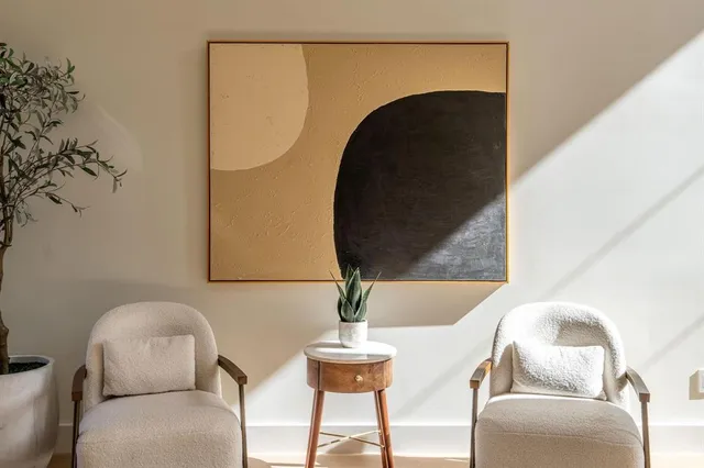 a living room with furniture and a potted plant