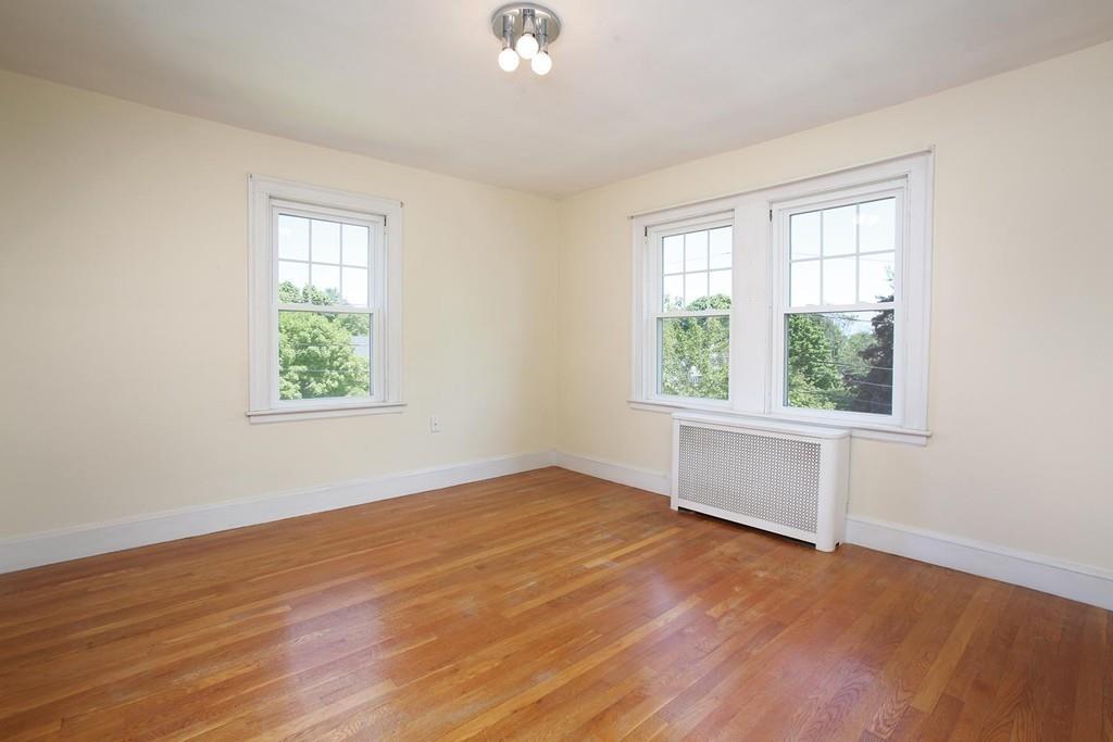7 Lodge Road Newton, MA 02465 - Photo 8 of 11 an empty room with wooden floor and windows