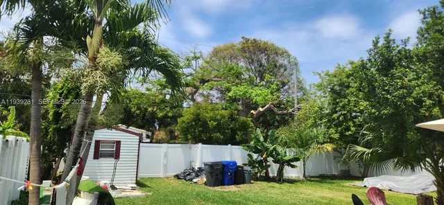 aerial view of a house with garden and trees