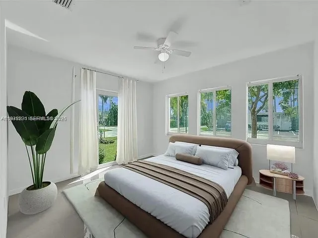 a bedroom with a balcony a bed and a chandelier