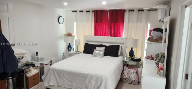 a bedroom with a bed and a fireplace