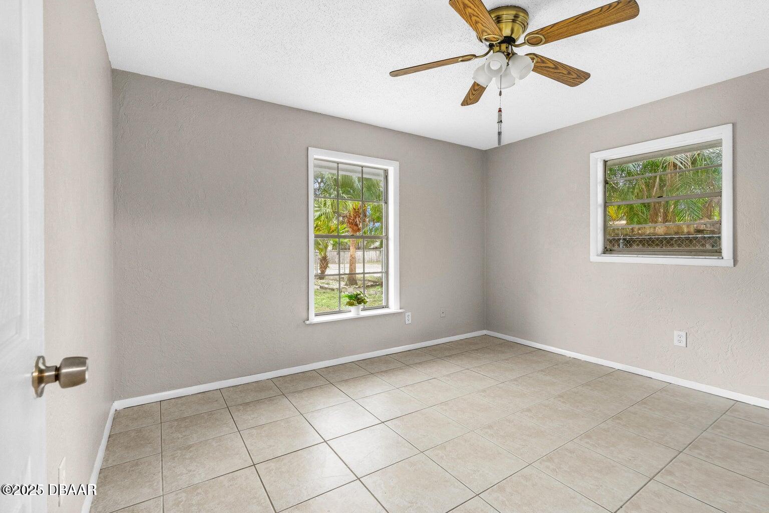 1702 Carolina Avenue Ormond Beach, FL 32174 - Photo 12 of 23 an empty room with windows and fan