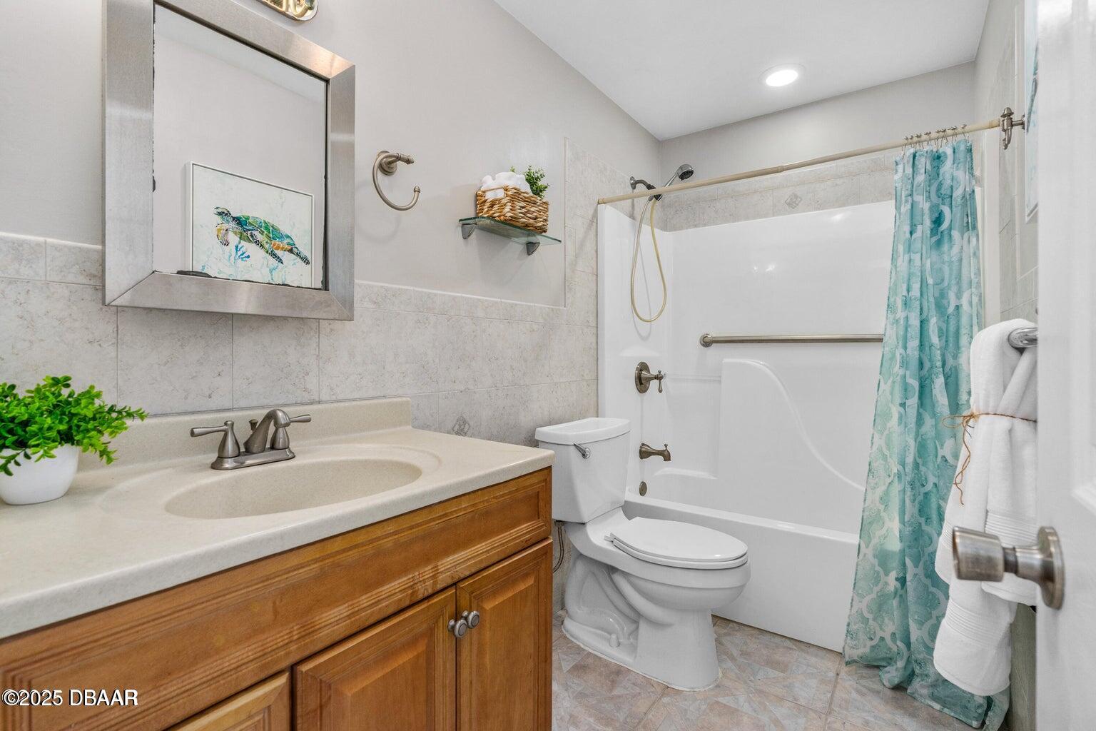 1702 Carolina Avenue Ormond Beach, FL 32174 - Photo 13 of 23 a bathroom with a sink a toilet and a shower