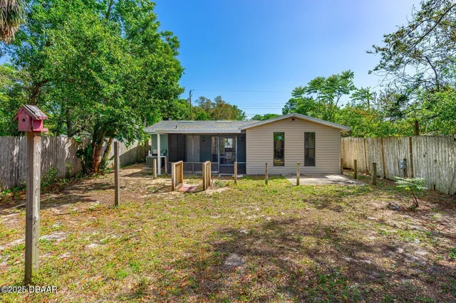 a view of a house with backyard and sitting area