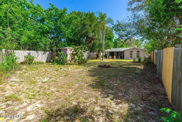 an aerial view of a house with a yard basket ball court and outdoor seating