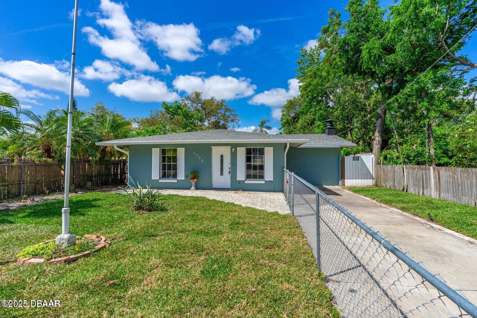 1702 Carolina Avenue Ormond Beach, FL 32174 - Photo 23 of 23 a view of a house with a yard and a garden