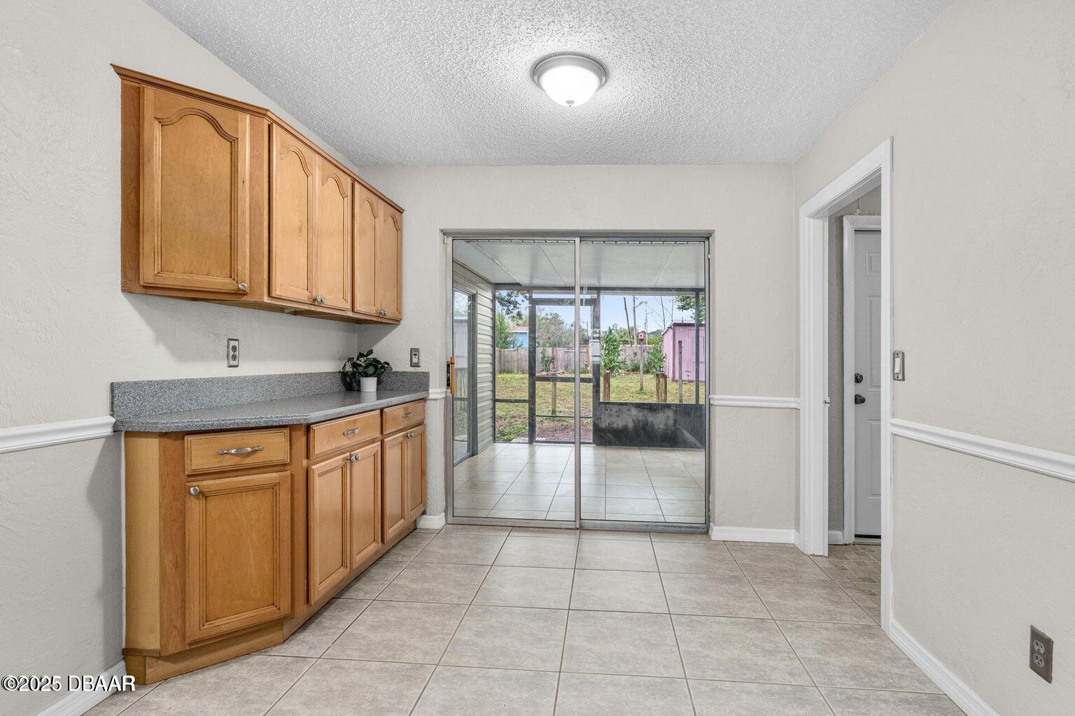 1702 Carolina Avenue Ormond Beach, FL 32174 - Photo 7 of 23 a large kitchen with granite countertop a refrigerator and a sink