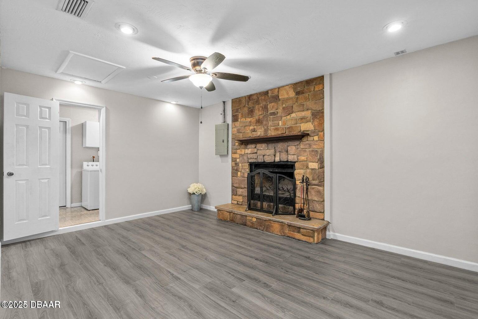 1702 Carolina Avenue Ormond Beach, FL 32174 - Photo 9 of 23 a view of an empty room with wooden floor fireplace and a window