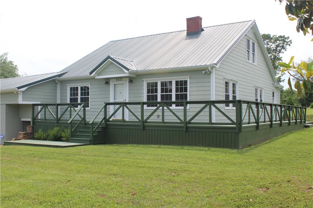 4123 Hickory Nut Ridge Road Hudson, NC 28638 - Photo 1 of 27 a front view of house with yard and outdoor seating