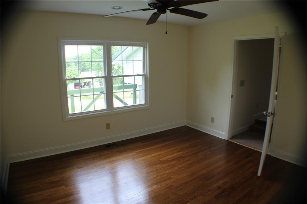 4123 Hickory Nut Ridge Road Hudson, NC 28638 - Photo 11 of 27 an empty room with wooden floor and windows