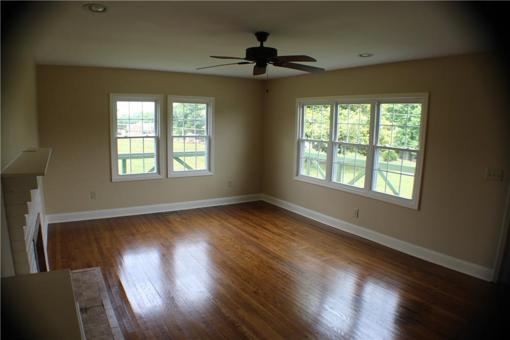 4123 Hickory Nut Ridge Road Hudson, NC 28638 - Photo 15 of 27 a view of an empty room with wooden floor and a window