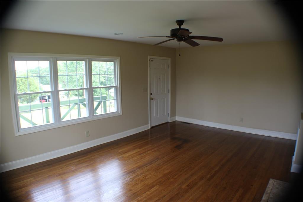 4123 Hickory Nut Ridge Road Hudson, NC 28638 - Photo 17 of 27 a view of an empty room with wooden floor and a window