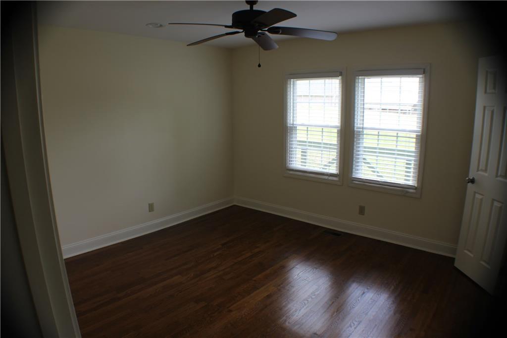 4123 Hickory Nut Ridge Road Hudson, NC 28638 - Photo 18 of 27 a view of an empty room with wooden floor and a window