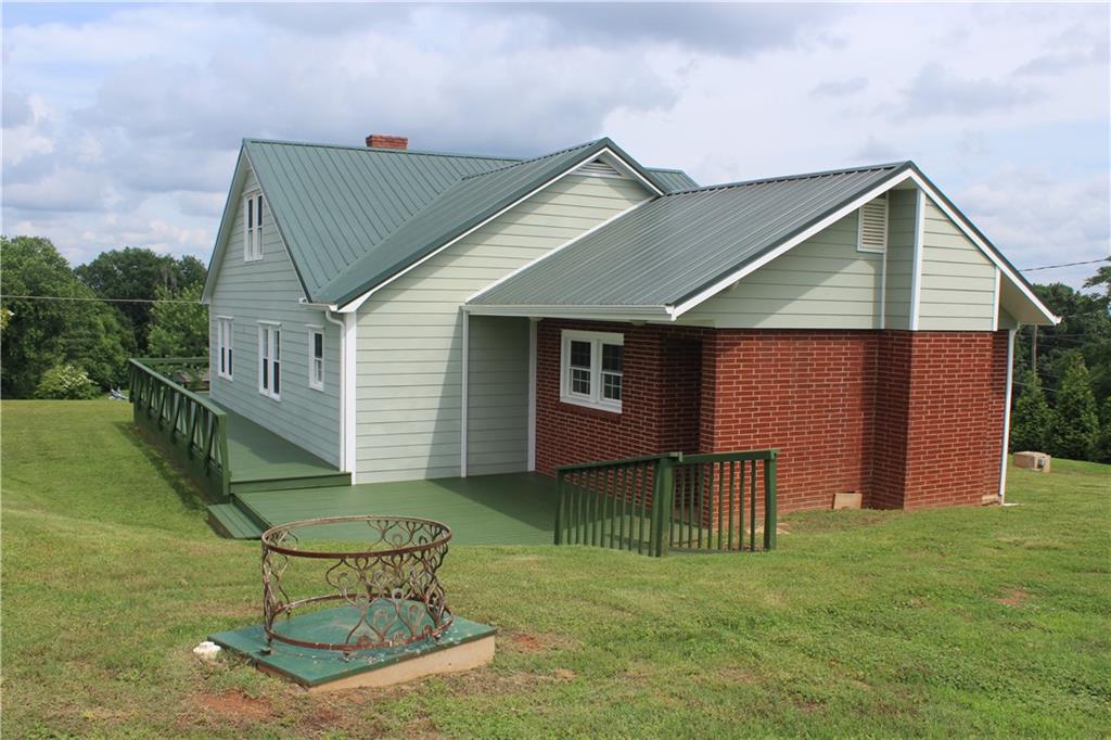 4123 Hickory Nut Ridge Road Hudson, NC 28638 - Photo 27 of 27 a backyard of a house with seating space