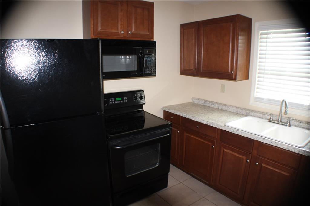 4123 Hickory Nut Ridge Road Hudson, NC 28638 - Photo 5 of 27 a kitchen with a sink stove and microwave
