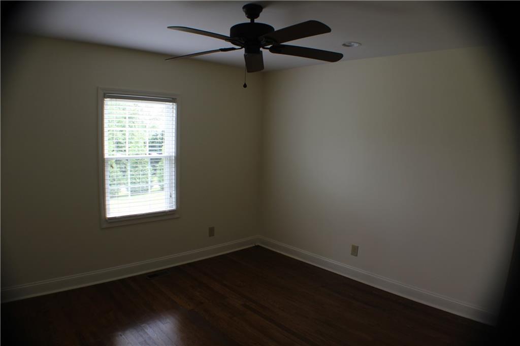 4123 Hickory Nut Ridge Road Hudson, NC 28638 - Photo 9 of 27 a view of an empty room with wooden floor and a window