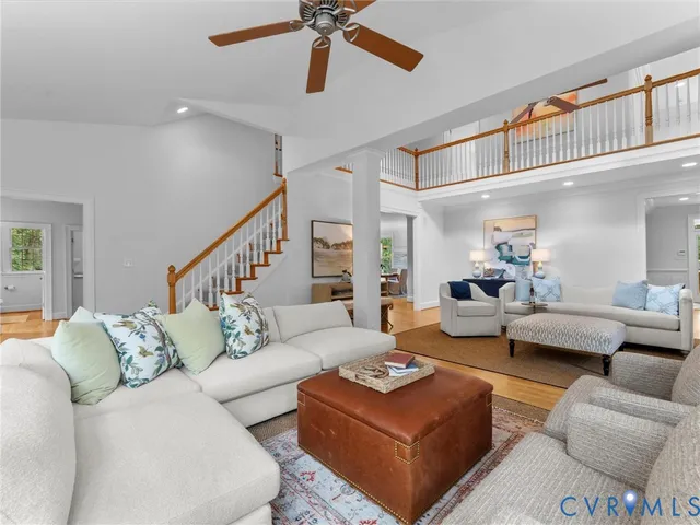 a dining room with furniture a chandelier and wooden floor