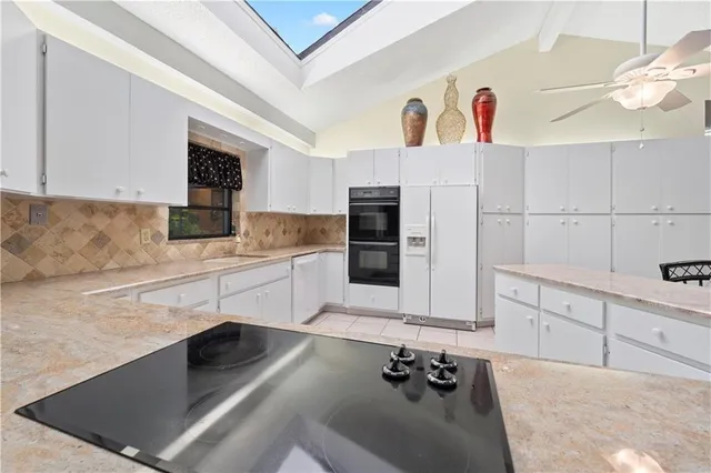 a kitchen with stainless steel appliances cabinets a sink and a stove