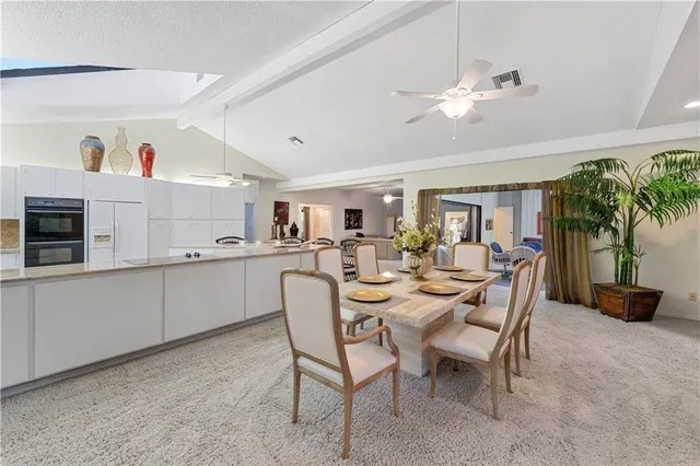 a view of a dining room with furniture and a livingroom