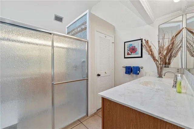 a bathroom with a shower and a sink