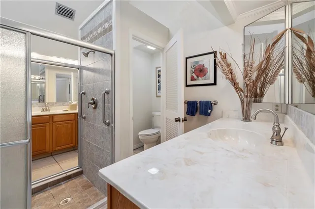 a bathroom with a sink mirror vanity and toilet